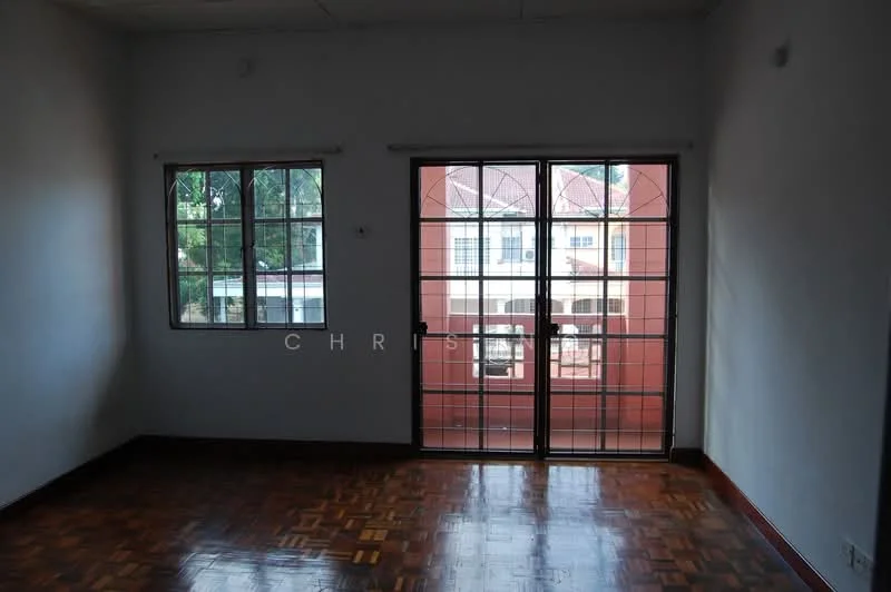 Room features: wooden flooring, white painted walls, two windows with metal grills, double sliding glass doors, view of exterior building, natural light from windows, ceiling with no visible fixtures.