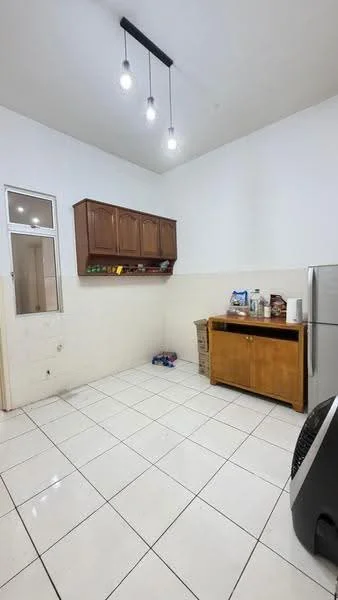 Kitchen features: white painted walls, ceramic tile flooring, wooden cabinetry, stainless-steel fridge, countertop, recessed ceiling lights, open space layout, window for natural light; style: modern.