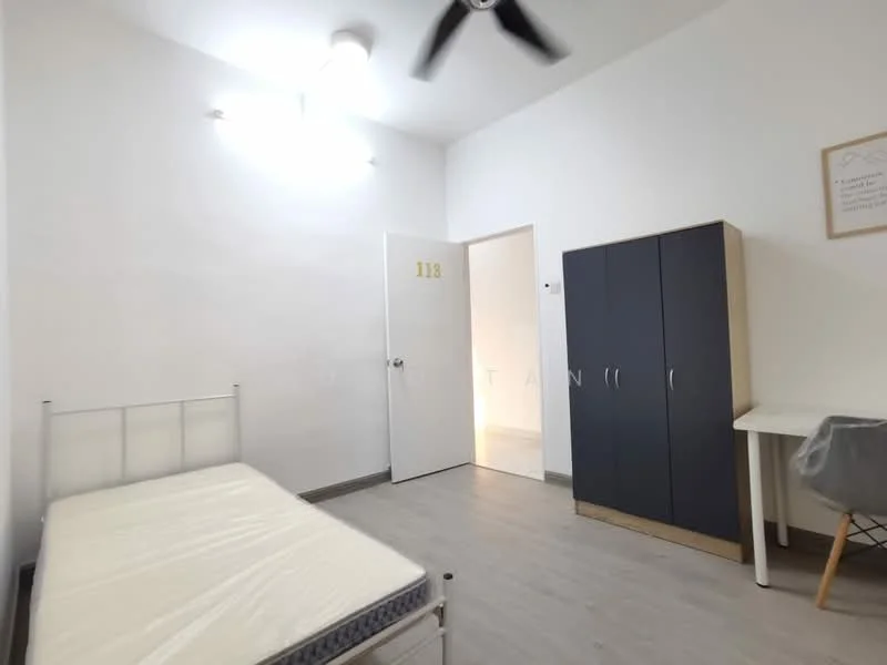 Bedroom features: single bed frame without mattress, white painted walls, light grey laminate flooring, ceiling fan, built-in wardrobe with two doors, study desk with chair, door leading to hallway, number 113 on door; style: minimalist.
