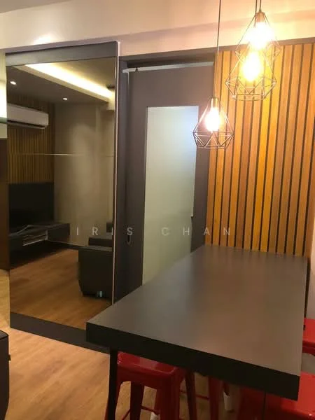 Dining features: black countertop, wooden accent wall with vertical slats, hanging pendant lights, red bar stools, light wood flooring, wall-mounted air conditioning unit, large mirror reflecting the living area, TV console in the background; style: modern.