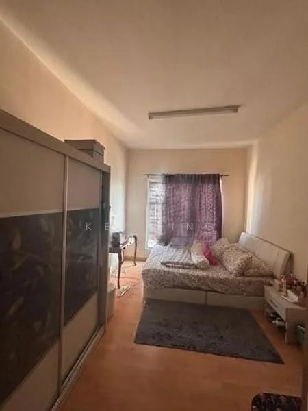 Bedroom features: queen-size bed with patterned bedding, wooden flooring, light-colored painted walls, large window with sheer curtains, dark purple curtain, built-in wardrobe with sliding doors, area rug, desk with chair.