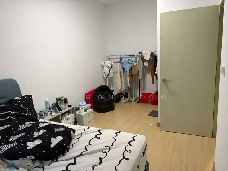Bedroom features: queen-size bed with patterned bedding, light wood flooring, white painted walls, built-in wardrobe with sliding door, clothes rack, nightstand with drawer, various personal items on the floor, window with no visible treatment; style: modern.