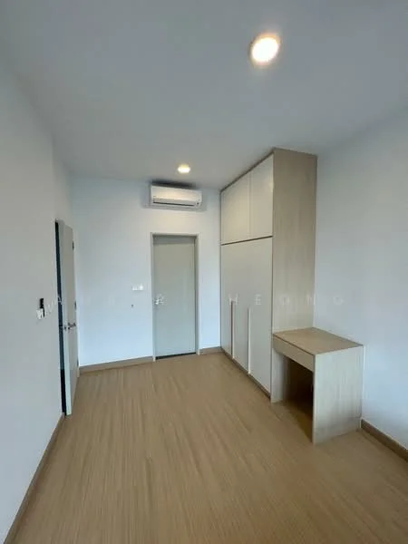 Room features: light wood laminate flooring, white painted walls, built-in wardrobe with sliding doors, wall-mounted air conditioning unit, desk or console table, door leading to another room, recessed ceiling lights; style: modern.