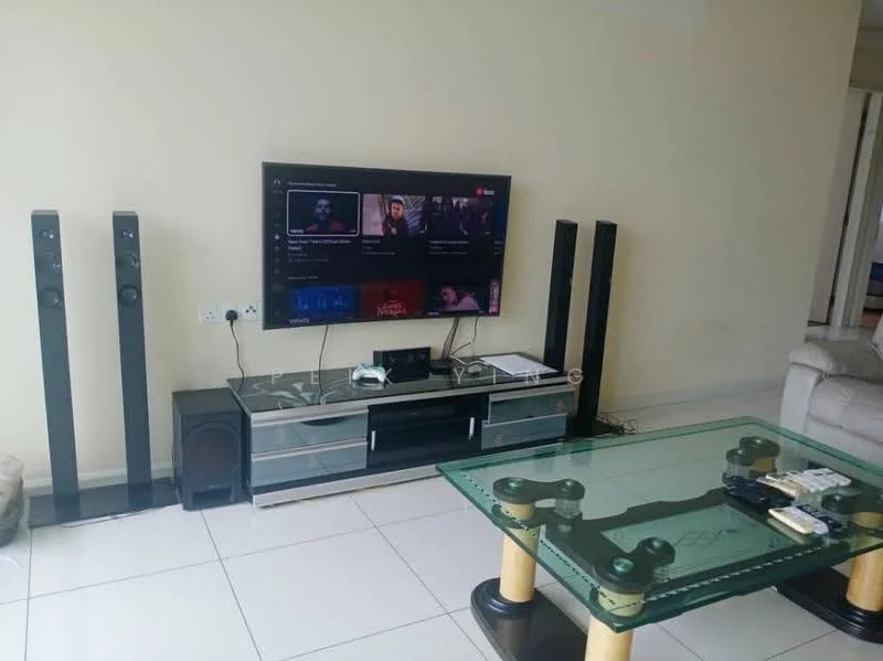 Living features: wall-mounted flat-screen TV, glass TV console, two tall speaker towers, subwoofer, coffee table with glass top, four wooden legs on coffee table, remote controls on coffee table, white tiled flooring, light beige painted walls, sofa in light color; style: modern.