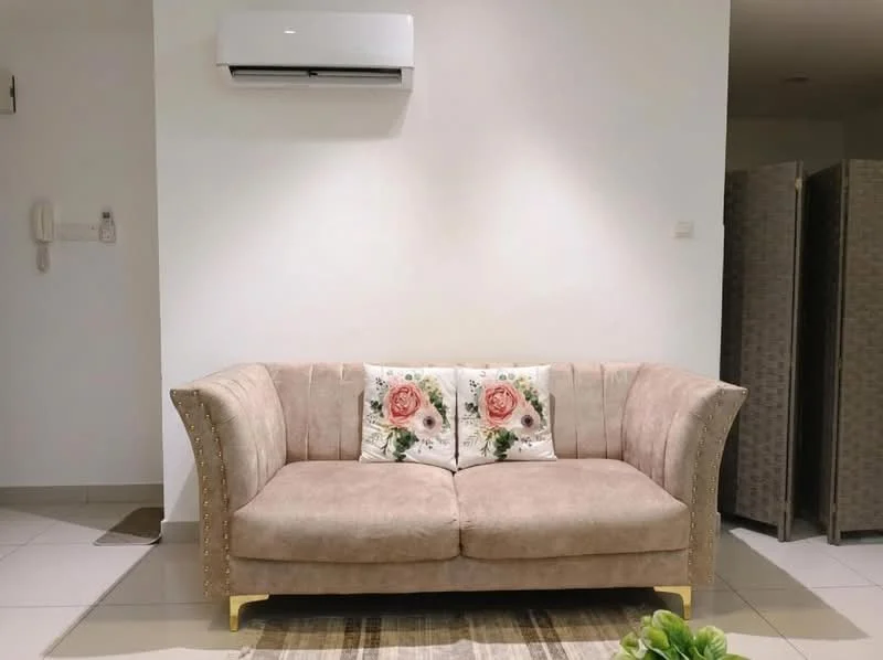 Living features: 3-seater fabric sofa in beige with decorative cushions, wall-mounted split AC, white painted walls, tile flooring, area rug with geometric pattern, decorative wall art, light switch on wall, neutral color scheme; style: modern.