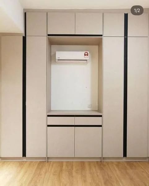 Room features: built-in cabinetry with beige finish, black accent handles, central open shelf space, air conditioning unit mounted on wall, wooden flooring; style: modern.