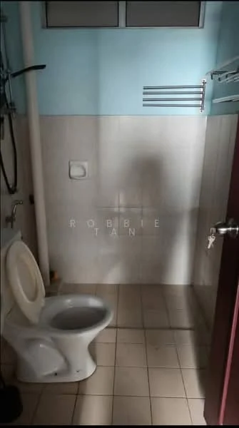 Bathroom features: white ceramic toilet, shower area with wall-mounted showerhead, tiled walls, light-colored floor tiles, chrome towel rack, window for natural light, light blue painted walls, neutral color scheme; style: modern.