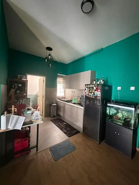 Kitchen features: green painted walls, sloped ceiling, stainless-steel fridge, stainless-steel kitchen cabinets, black countertop, sink, kitchen island, kitchen appliances, tile flooring, pendant light, wall-mounted cabinets, open shelving, decorative items on countertop, aquarium, door leading to hallway; style: modern.