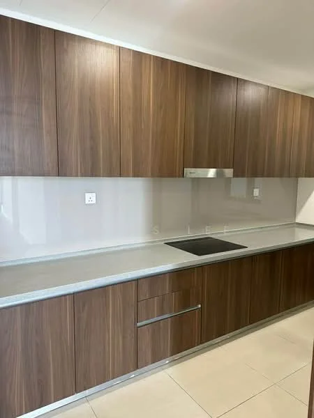 Kitchen features: wood cabinetry, grey countertop, built-in cooktop, stainless-steel range hood, white backsplash, under-cabinet lighting, ceramic tile flooring, single-bowl stainless-steel sink; style: modern.