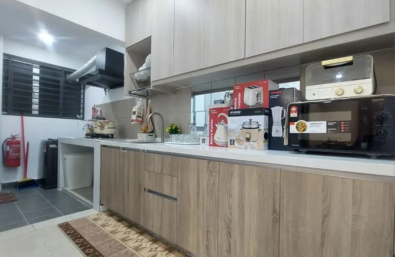 Kitchen features: laminate cabinetry in light wood finish, white countertop, single-bowl stainless-steel sink, chrome pull-down faucet, built-in oven, microwave, toaster, rice cooker, blender, fire extinguisher, tile flooring in grey, window with black grille, decorative rug; style: modern.