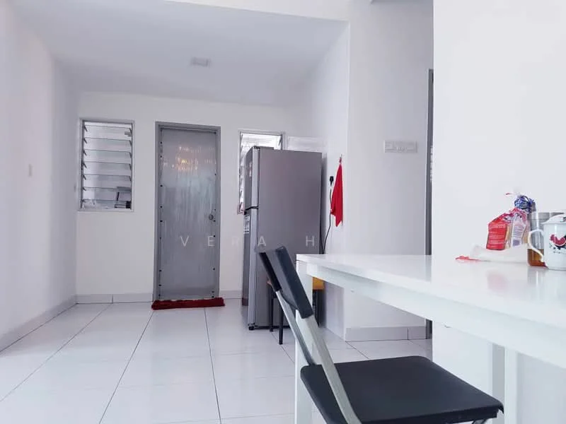 Room features: white painted walls, white tiled flooring, single door, fridge, table with four legs, black chair, window with metal grille, door mat; style: modern.