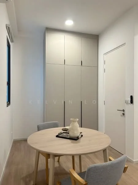 Dining features: round wooden dining table, 3 upholstered dining chairs in light grey, white walls, light wood flooring, built-in cabinetry in light grey, single door, window with black frame, recessed ceiling lights; style: modern.