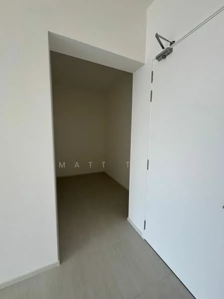 Room features: white painted walls, light grey tile flooring, door with handle, arched entryway.
