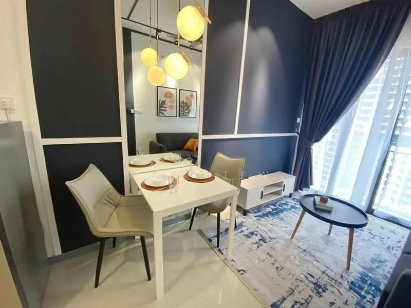 Dining features: white dining table, 4 dining chairs in light grey, pendant lighting with three globes, blue and white area rug, dark blue accent wall, floor-to-ceiling windows with sheer curtains, small TV console, decorative items on console; style: modern. Living features: grey fabric sofa, decorative throw pillows, wall-mounted mirror, open space layout; style: modern.