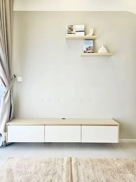 Room features: light grey painted walls, light wood floating shelf, white low-profile media console with drawers, beige area rug, floor-to-ceiling curtains in light grey, minimalist decor items on shelf; style: minimalist.