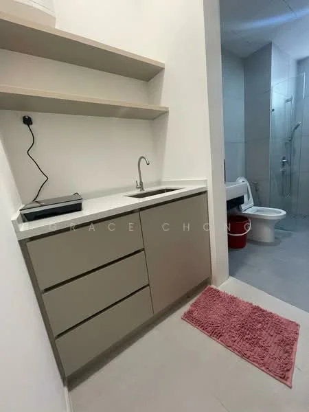 Laundry features: single-bowl stainless-steel sink, chrome pull-down faucet, grey cabinetry with three drawers, white countertop, open shelving above sink, pink bath mat, grey tile flooring, glass shower enclosure visible in background, toilet visible in background; style: modern.