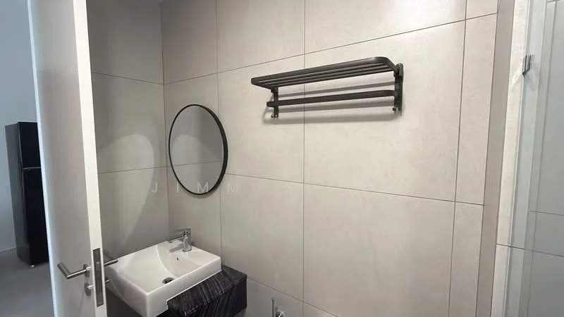 Bathroom features: grey tiled walls, grey tiled flooring, round mirror, single-bowl sink, chrome faucet, black towel rack, glass shower enclosure, wall-mounted shelving; style: modern.