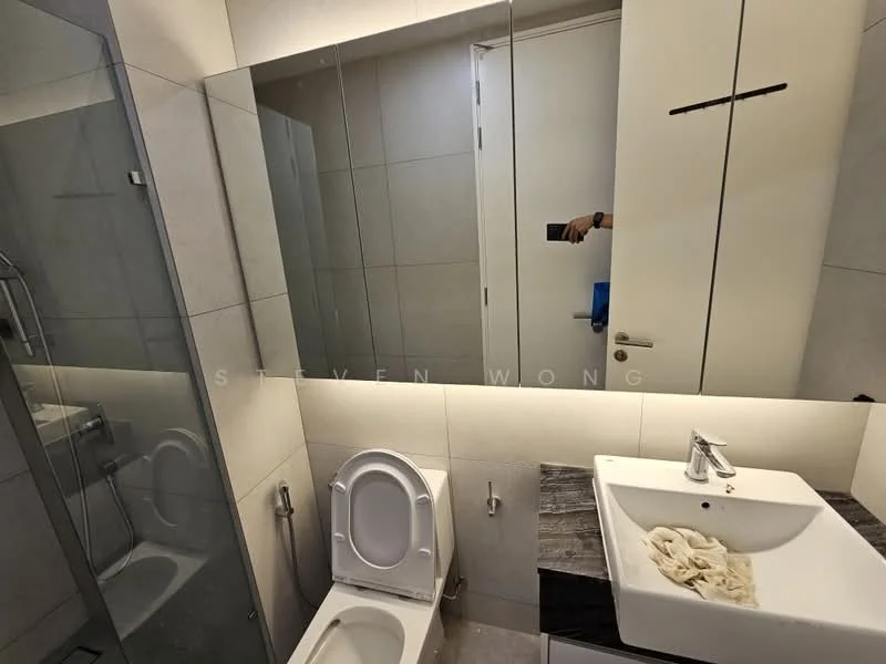 Bathroom features: grey tiled walls, grey tiled flooring, walk-in shower with glass enclosure, chrome shower head, single-sink vanity with white cabinet, chrome basin mixer, framed mirror, one-piece toilet, LED lighting, towel rack; style: modern.