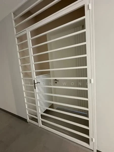 Room features: white metal security gate, white door, grey tiled flooring, neutral wall colour, horizontal slats on gate, door handle, light switch, door frame; style: modern.