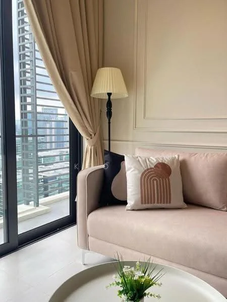 Living features: beige fabric sofa, decorative pillow with abstract design, floor lamp with cream lampshade, curtains in light beige, glass sliding door, city view through window, light-colored wall with paneling, round coffee table, small decorative plant on coffee table; style: modern; view: city.