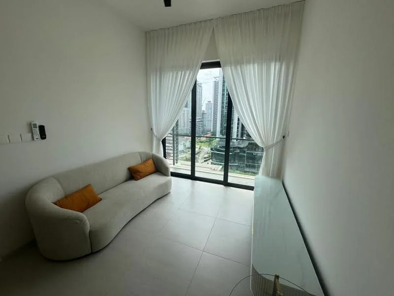 Living features: curved beige fabric sofa, two orange throw pillows, floor-to-ceiling windows, sheer white curtains, light grey tiled flooring, minimalist TV console, city skyline view, recessed ceiling lights; style: modern; view: city.