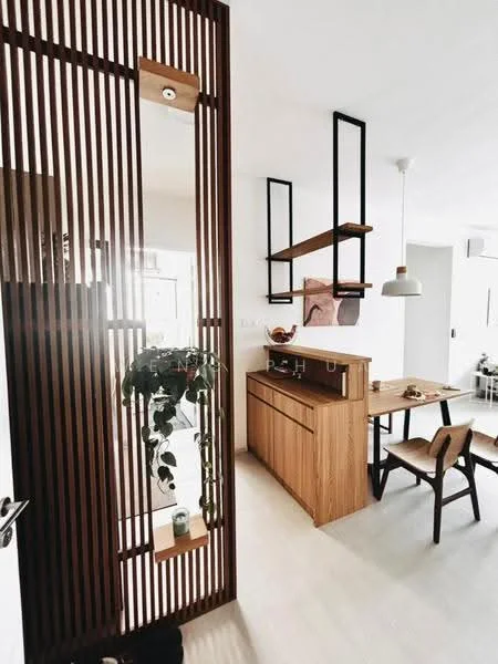 Room features: wooden slat partition, light wood cabinetry, open shelving, dining table with chairs, pendant light fixture, decorative plant, white walls, light-colored flooring; style: modern.