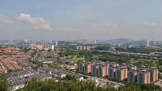 Exterior type: mid-rise condominium; features: urban skyline view, surrounded by greenery, multiple low-rise residential buildings, open landscape area, city in the background, clear blue sky; style: modern.