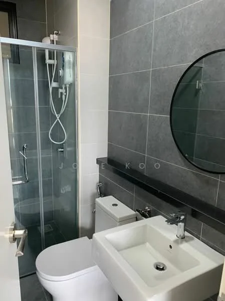 Bathroom features: grey tiled walls, white ceramic sink, chrome basin mixer faucet, round mirror, white toilet, glass shower enclosure, shower head, black countertop, wall-mounted shower controls, sliding door, built-in shelving; style: modern.