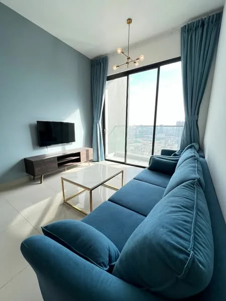 Living features: blue upholstered sofa, gold coffee table with marble top, wall-mounted TV, floor-to-ceiling windows, sheer curtains, recessed ceiling lights, light fixture with multiple bulbs, neutral tiled flooring, accent wall in blue, open view of the city; style: modern; view: city.