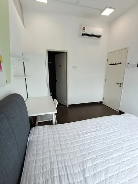 Bedroom features: queen-size bed with white quilted bedding, grey upholstered headboard, white study desk, white chair, wall-mounted air conditioning unit, white painted walls, dark wood laminate flooring, door leading to hallway, built-in wardrobe, ceiling lights; style: modern.