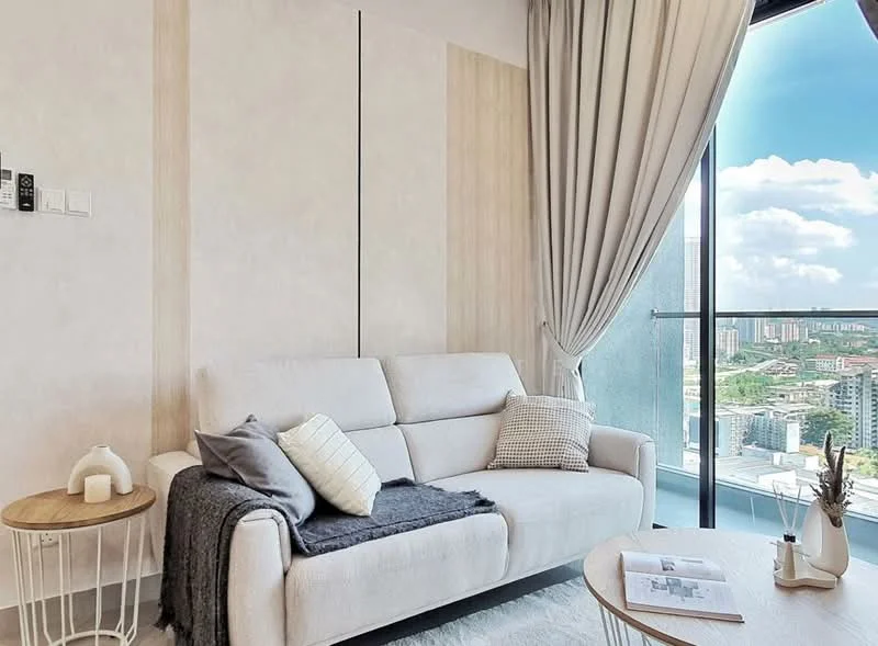 Living features: light grey fabric sofa, decorative throw pillows, wooden side table, white ceramic decorative item, textured wall panels, floor-to-ceiling windows, sheer curtains, city view, area rug, decorative magazine, throw blanket; style: modern; view: city.
