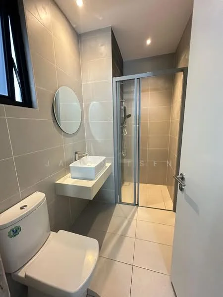 Bathroom features: grey tiled walls, white ceramic floor tiles, single-sink vanity with rectangular basin, chrome basin mixer faucet, framed round mirror, walk-in shower with glass enclosure, rain shower head, one-piece toilet, recessed ceiling lights, sliding glass door; style: modern.