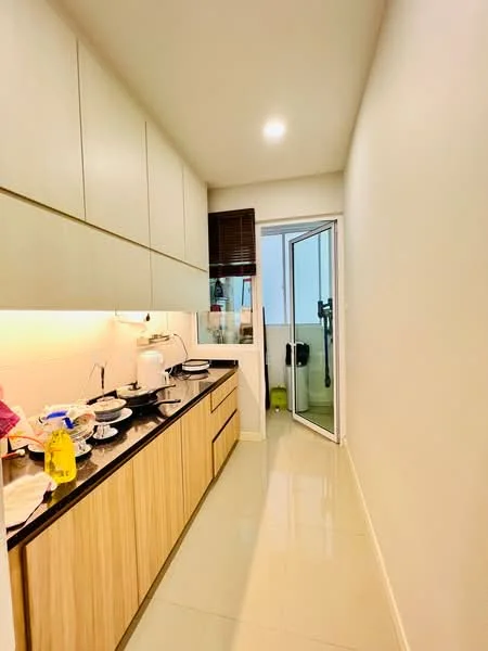 Kitchen features: light wood cabinetry, black countertop, stainless-steel sink, chrome faucet, built-in cabinets, white walls, glossy tile flooring, recessed lighting, sliding glass door, window with view to outside, kitchen appliances visible, dishes and utensils on countertop; style: modern.