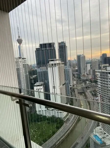 Room features: floor-to-ceiling windows, glass balcony railing, city skyline view, high-rise buildings, urban landscape, curved road, distant telecommunications tower, cloudy sky; style: modern; view: city.