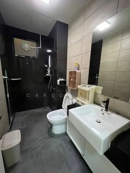 Bathroom features: black tiled walls, light beige tiled walls, grey tile flooring, single-sink vanity with white cabinet, chrome basin mixer faucet, framed mirror, one-piece toilet, walk-in shower with glass enclosure, rain shower head, handheld shower, shower wall with black tiles, toilet paper holder, small waste bin; style: modern.