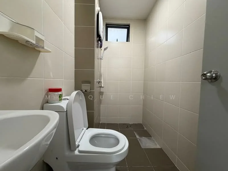 Bathroom features: white ceramic toilet, single-sink vanity with white cabinet, chrome basin mixer faucet, tile flooring in dark grey, wall-mounted shower head, white tiled walls, small window for ventilation, shelf above sink; style: modern.