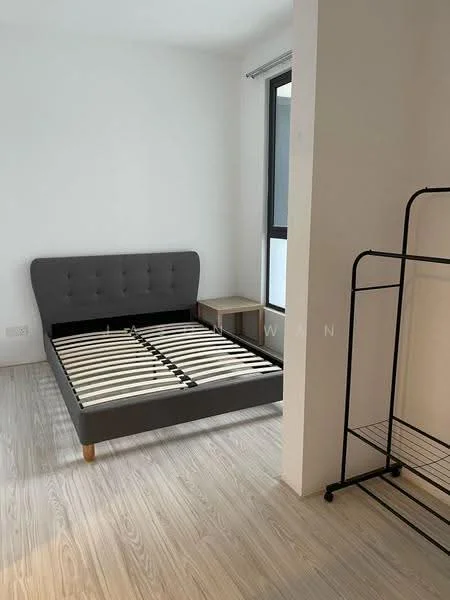 Bedroom features: queen-size bed frame without mattress, light wood flooring, white painted walls, large window with black frame, minimalist bedside table, metal clothing rack, natural light from window; style: minimalist.