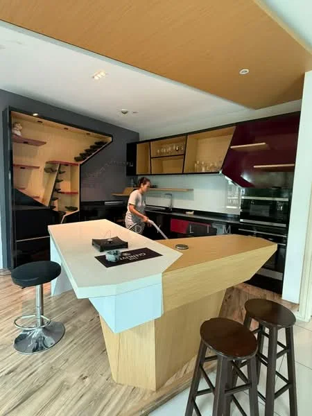 Kitchen features: island kitchen with unique geometric shape, wooden countertop, black cabinetry with glossy finish, purple accent cabinetry, built-in oven, stainless-steel range hood, 4-burner gas hob, open shelving, glass-front upper cabinets, bar stools, wooden flooring, recessed downlights, stainless-steel sink, modern faucet; style: modern.