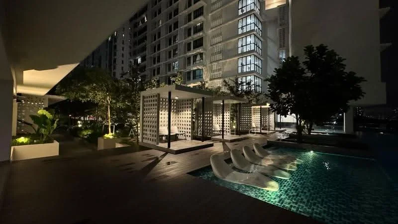 Exterior type: high-rise condominium; features: infinity pool, pool deck with loungers, landscaped garden, outdoor seating area with pergolas, mature trees, ambient lighting, wooden decking, water feature, surrounded by greenery; style: modern.