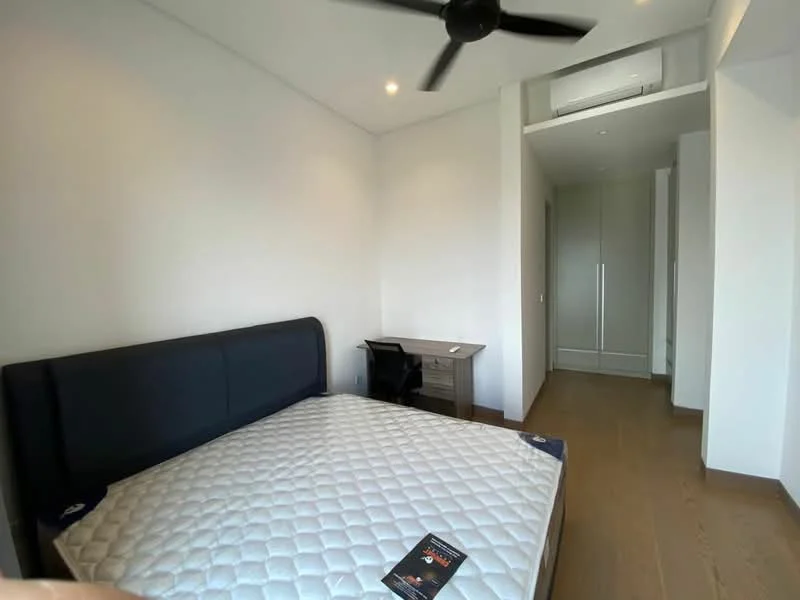 Bedroom features: king-size bed, upholstered headboard, wooden flooring, 5-blade ceiling fan, wall-mounted split AC, study desk, built-in wardrobe, neutral painted walls, natural light from window; style: modern.
