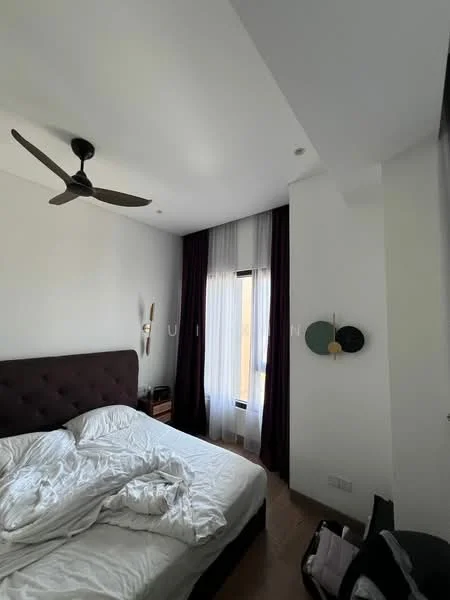 Bedroom features: king-size bed with upholstered headboard, white bed linens, 5-blade ceiling fan, floor-to-ceiling window, sheer curtains, dark purple curtains, wooden flooring, decorative wall art, nightstand, lamp on nightstand; style: modern.