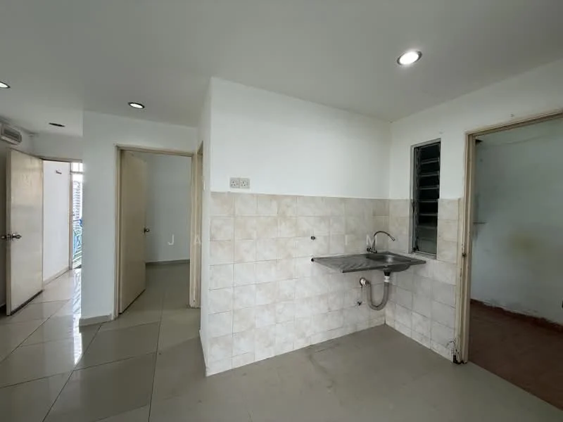 Room features: white painted walls, light grey tiled flooring, stainless-steel sink, wall-mounted faucet, window with metal grille, doorway leading to another room, doorway leading to hallway, fluorescent ceiling lights.