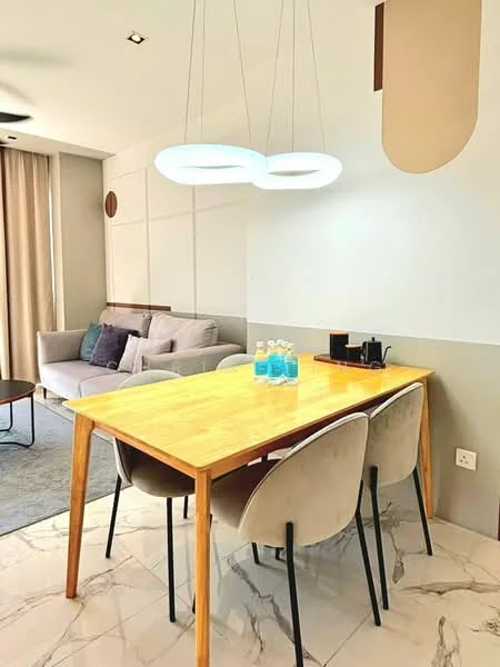 Dining features: wood dining table, 4 upholstered dining chairs, modern pendant lighting, marble tile flooring, grey accent wall, light-colored walls, sofa in background, decorative cushions on sofa, floor-to-ceiling curtains, glass water bottles on table, coffee machine on side table; style: modern.