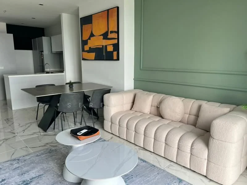 Living features: beige tufted sofa, round coffee table, area rug with geometric pattern, green accent wall, marble tile flooring, wall-mounted artwork, dining table with black chairs, open kitchen area with cabinetry; style: modern.