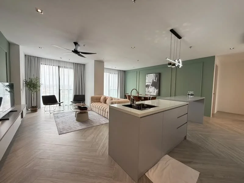 Living features: 5-blade ceiling fan with light, floor-to-ceiling windows, grey accent wall, light wood flooring, L-shape sectional sofa in beige, coffee table, TV console, area rug with geometric pattern, decorative plant in ceramic pot, wall-mounted TV, recessed downlights, sheer curtains; style: modern; view: city. Kitchen features: island kitchen with breakfast bar, single-bowl stainless-steel sink, chrome pull-down faucet, quartz countertop, built-in oven, freestanding range oven, stainless-steel range hood, flat-panel grey cabinets, recessed downlights; style: modern.