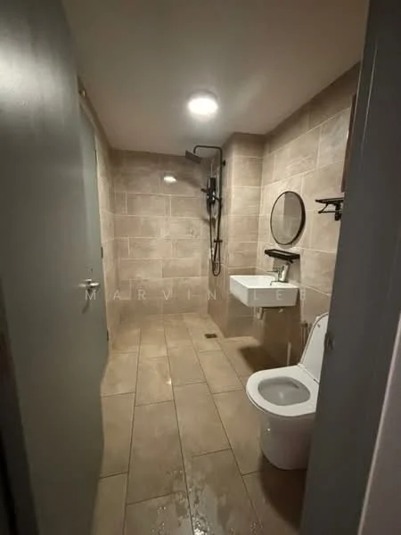 Bathroom features: wall-mounted shower with handheld attachment, round mirror, single-sink vanity with wall-mounted faucet, one-piece toilet, tile flooring, beige tiled walls, recessed ceiling lights, black wall-mounted shelf; style: modern.