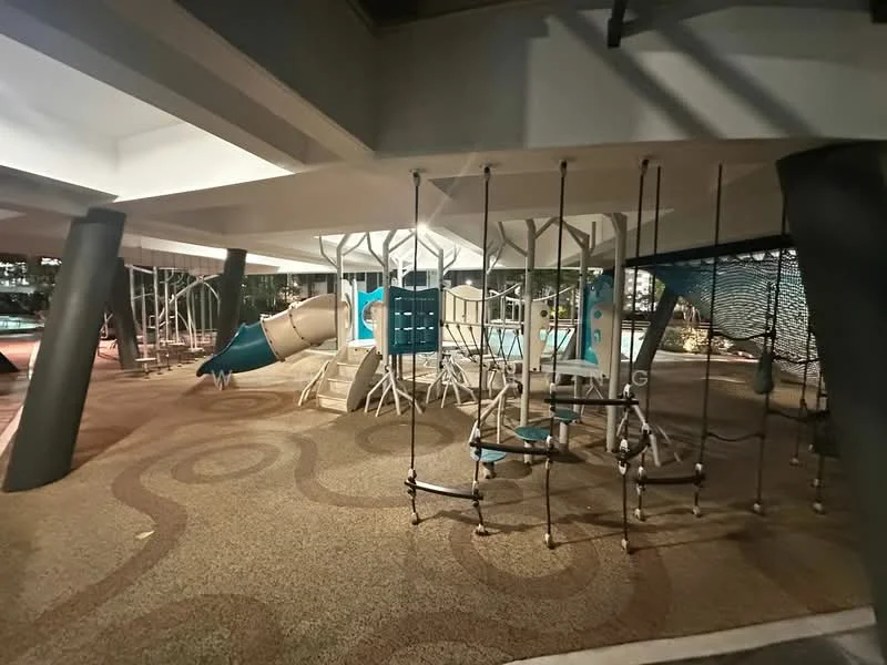 Exterior type: playground; features: play structure with slide, climbing frame, swing set, rubberized flooring, covered area, decorative lighting, surrounding landscaping; style: modern.