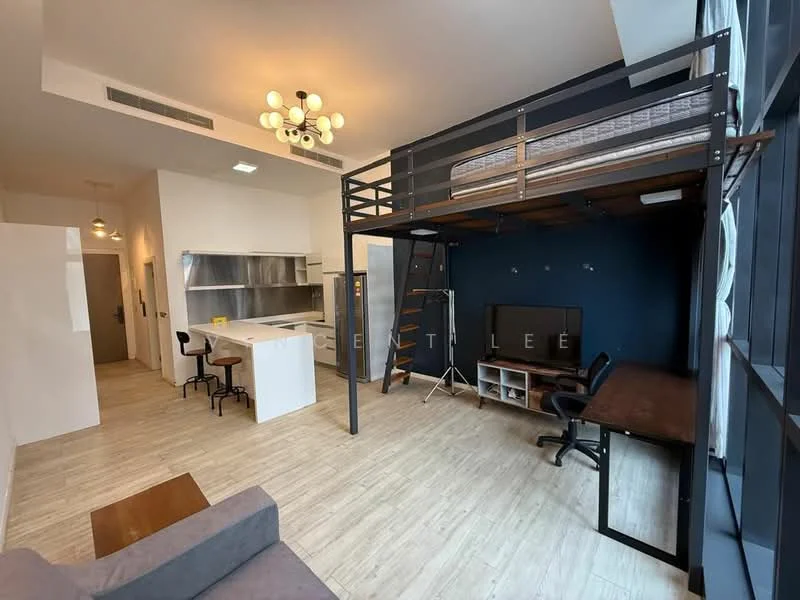 Living features: lofted bed frame, queen-size mattress, black metal ladder, sofa in grey fabric, wooden coffee table, study desk with chair, wall-mounted TV, refrigerator, kitchen island with seating, stainless-steel sink, chrome faucet, pendant lighting, large windows with natural light, wood-look vinyl flooring, blue accent wall; style: modern.
