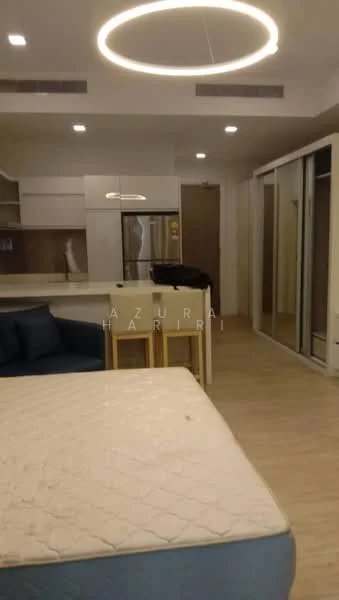 Living features: light wood flooring, white painted walls, recessed downlights, circular pendant light, sofa with blue upholstery, kitchen island with seating, built-in cabinetry, stainless-steel fridge, sliding glass wardrobe doors, open-plan layout; style: modern.