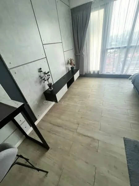 Bedroom features: light wood plank flooring, grey accent wall with paneling, floor-to-ceiling windows, sheer curtains, black floating shelf, decorative plants on shelf, bed with grey bedding, study desk with chair; style: modern; view: garden.